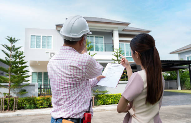 Property inspector explaining inspection report to Houston property buyer